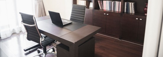 Modern home office with bookshelves.